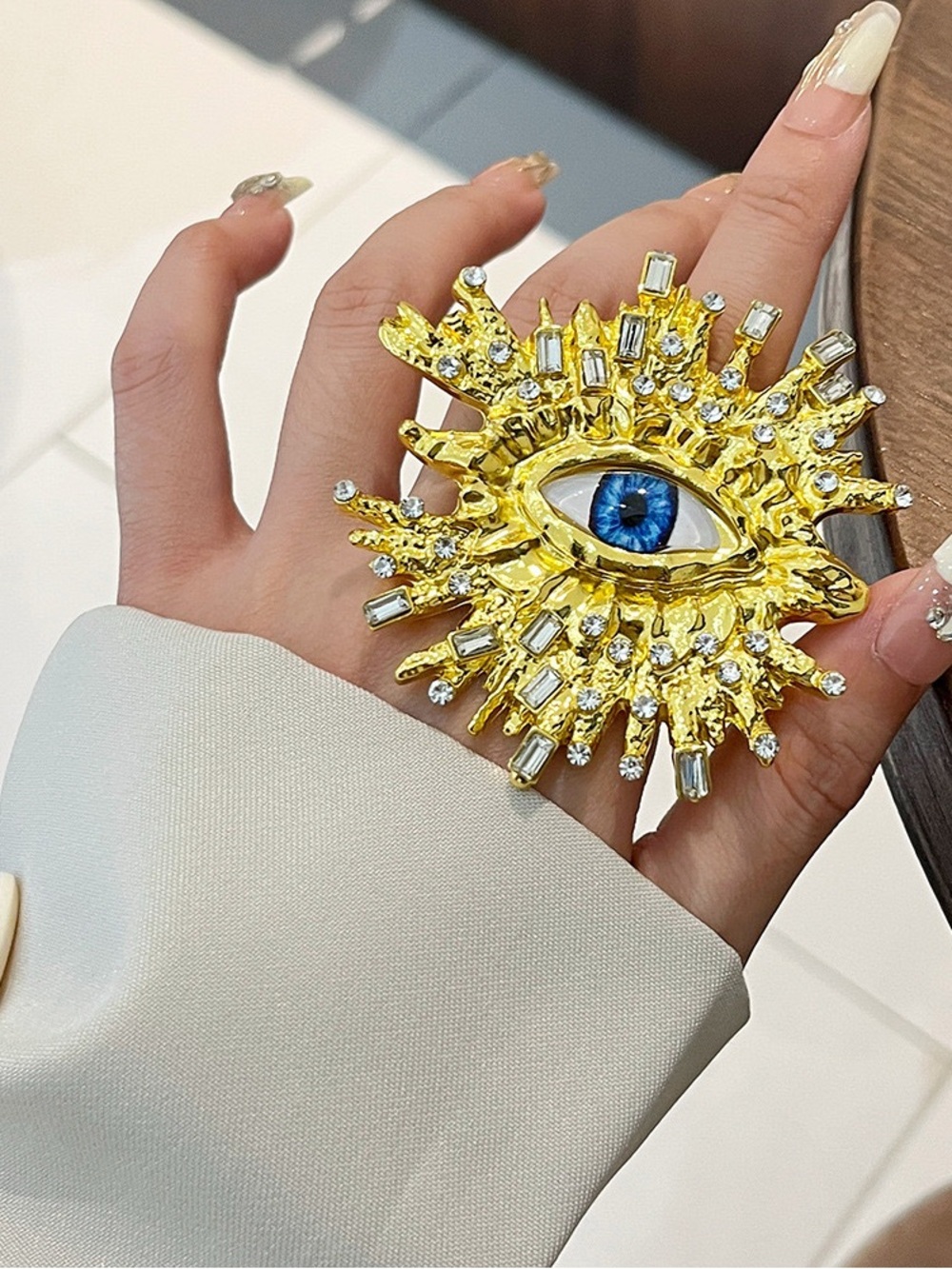 Gold Eye Statement Brooch with Blue Accent